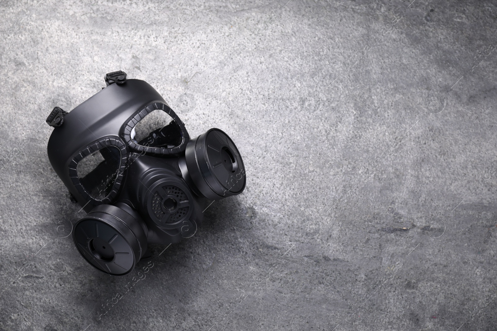 Photo of One gas mask on grey textured background, top view. Space for text