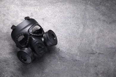 Photo of One gas mask on grey textured background, top view. Space for text