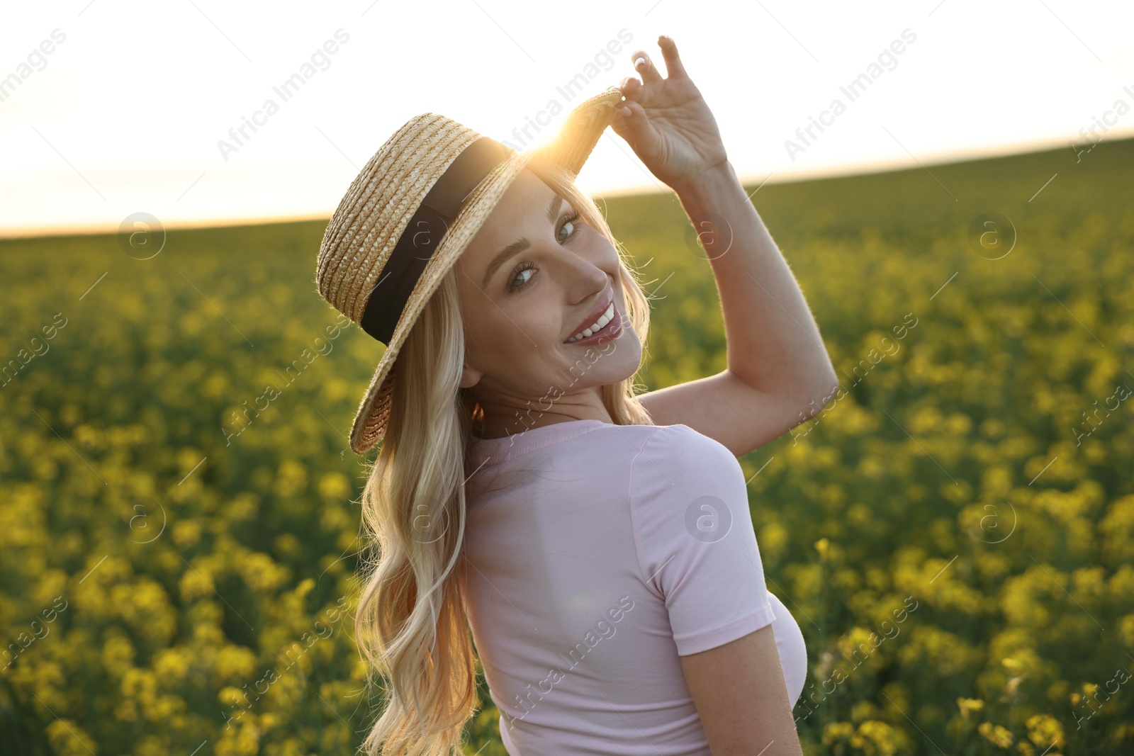 Photo of Portrait of happy young woman in field on spring day