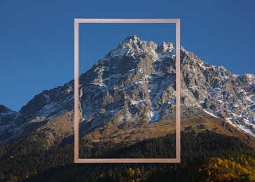 Image of Wooden frame and beautiful mountains under blue sky