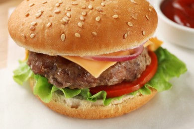 Photo of Tasty hamburger with patty, cheese and vegetables on white table, closeup