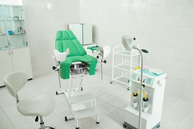 Modern gynecological office interior with examination chair and medical equipment
