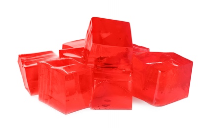 Photo of Heap of red jelly cubes on white background