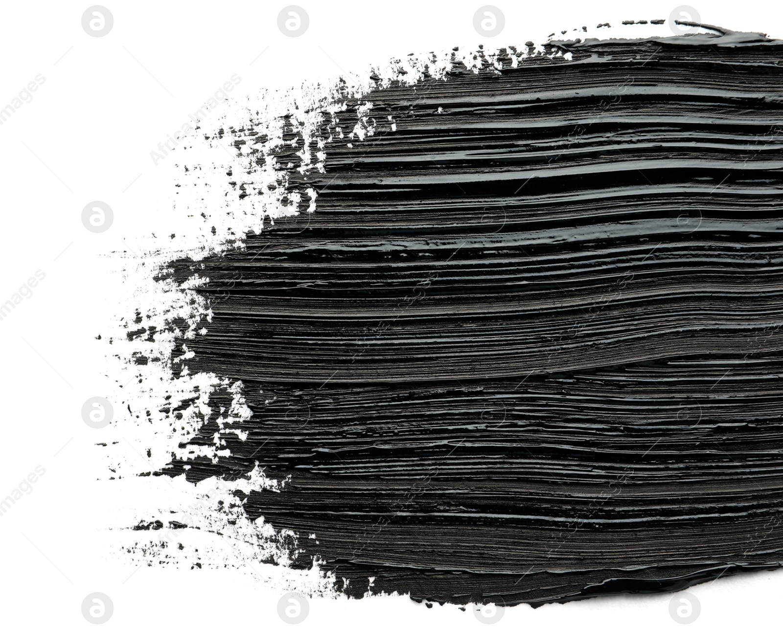 Photo of Brushstrokes of black oil paint on white background, top view