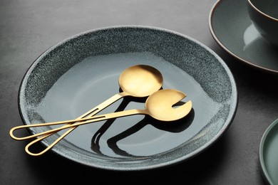 Photo of Stylish empty dishware and utensils on grey table, closeup