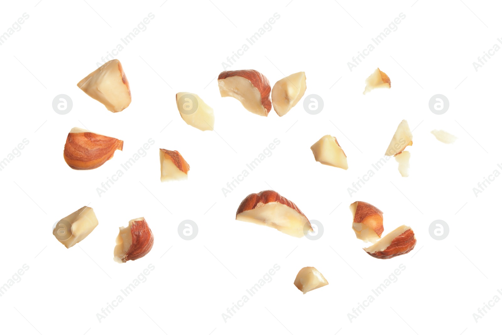 Photo of Pieces of tasty hazelnuts on white background