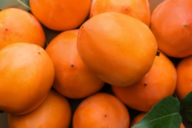 Photo of Delicious ripe juicy persimmons as background, top view