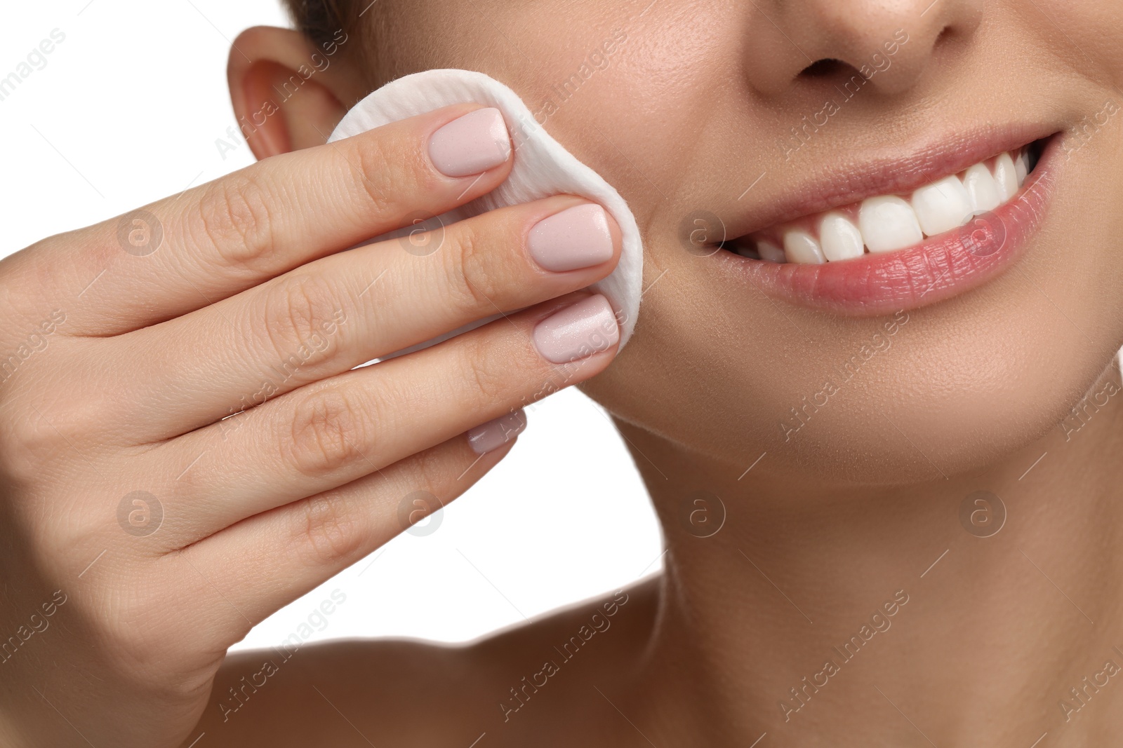 Photo of Smiling woman removing makeup with cotton pad on white background, closeup