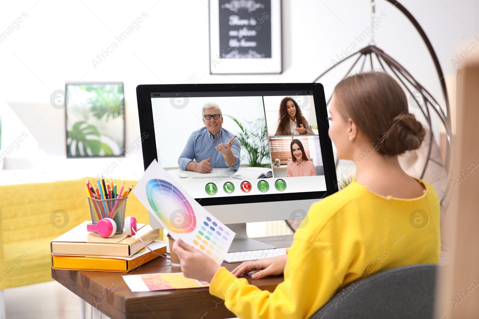 Image of Woman having video chat with colleagues at table in office. Team work  