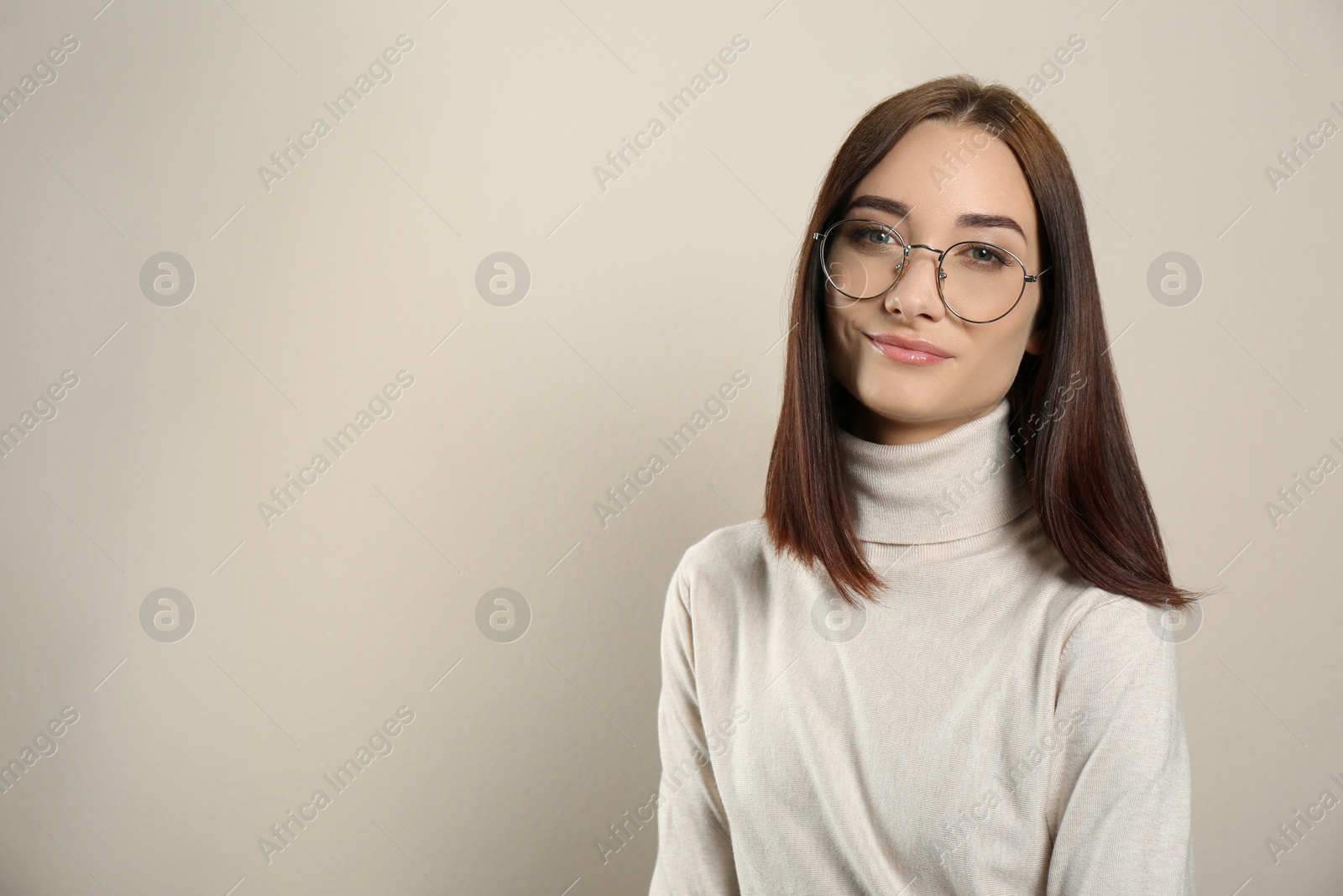 Photo of Portrait of pretty young woman with gorgeous chestnut hair on light background, space for text