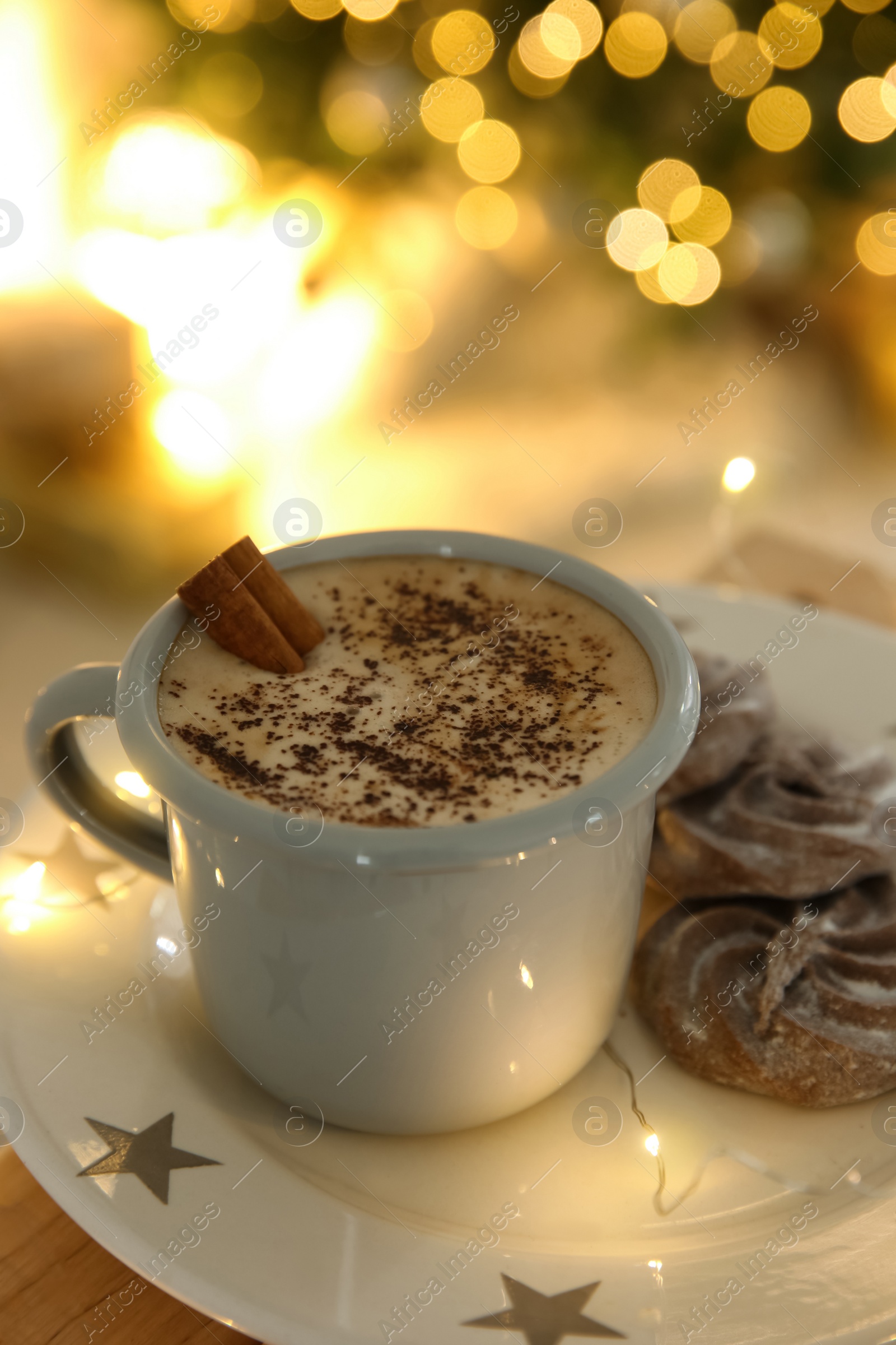 Photo of Tasty hot drink, cookies and Christmas lights, closeup