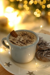 Photo of Tasty hot drink, cookies and Christmas lights, closeup