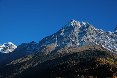 Picturesque view of beautiful high mountain under blue sky on sunny day