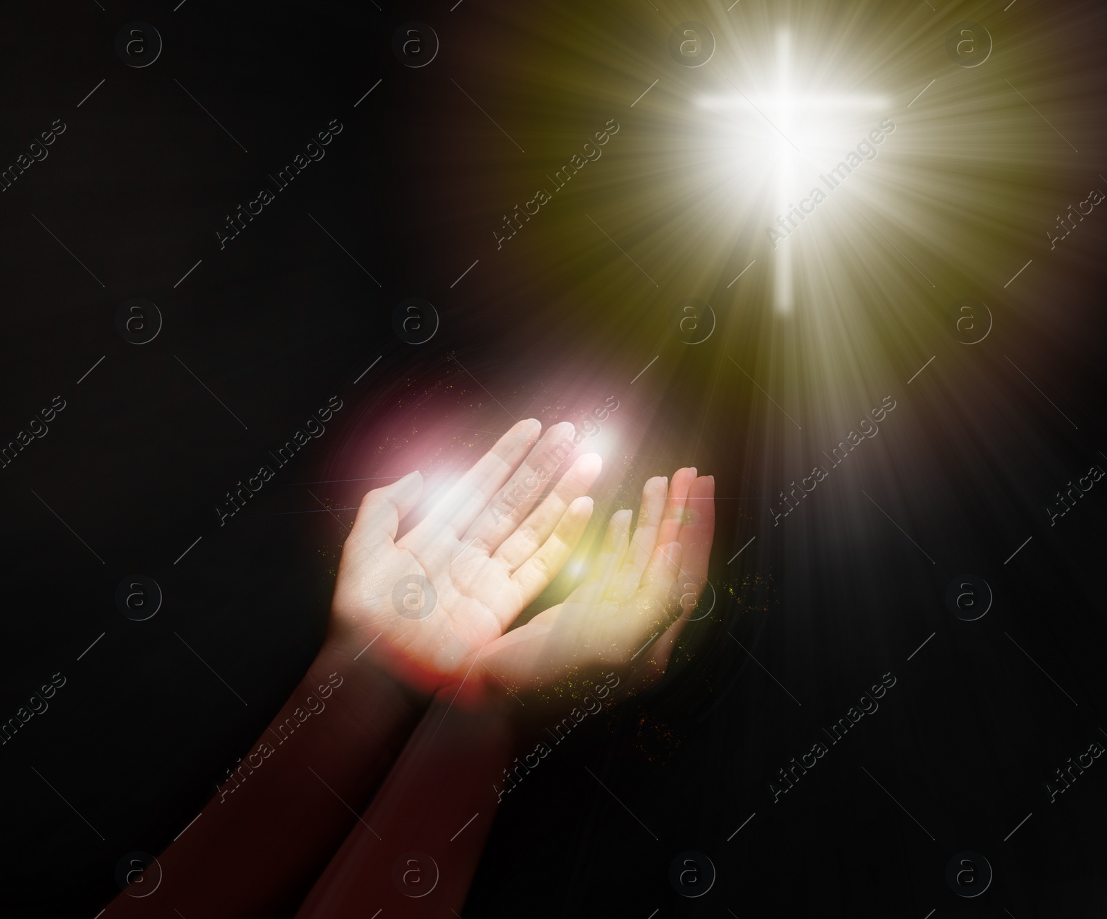 Image of Woman stretching hands towards cross silhouette in darkness, closeup. Praying concept