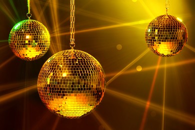 Image of Shiny bright disco balls under color lights