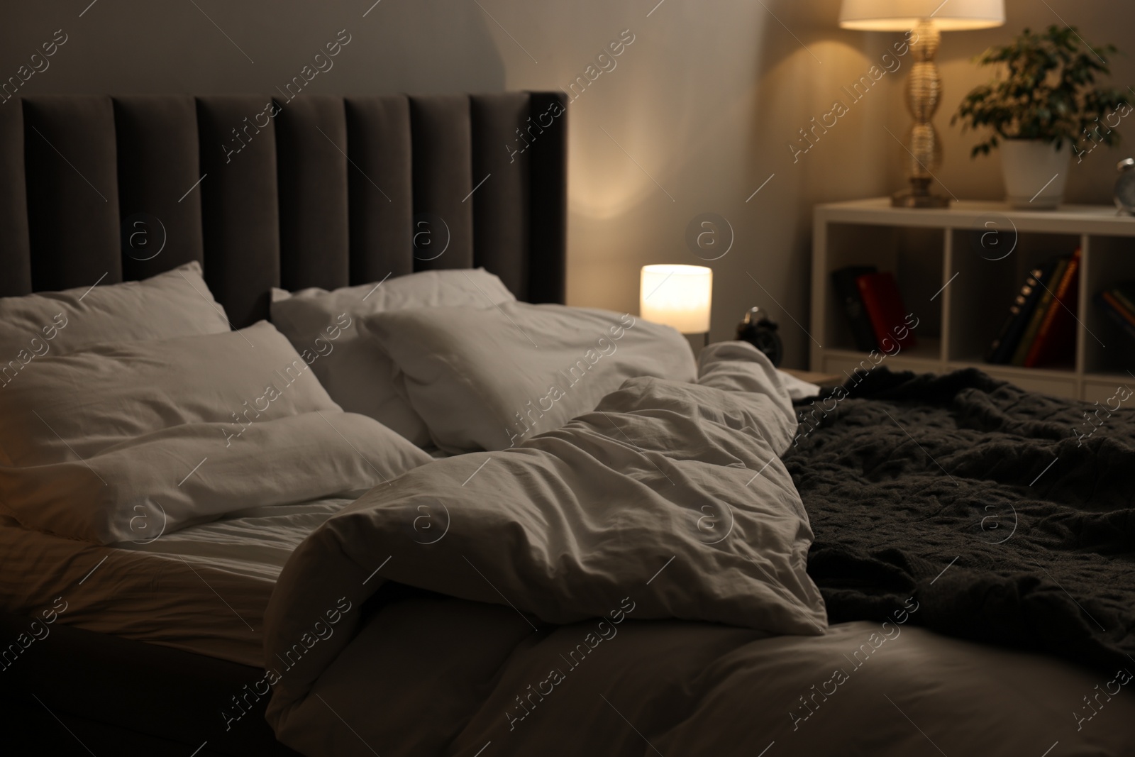 Photo of Soft bed, nightlight and cozy furniture indoors
