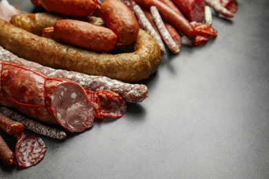 Different types of sausages on grey table. Space for text