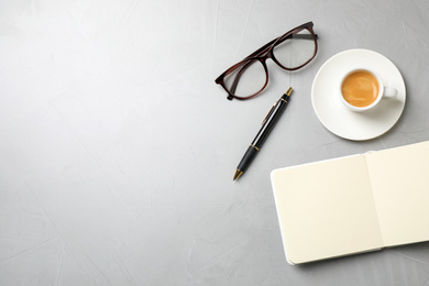 Flat lay composition with coffee on grey table, space for text. Tasty breakfast