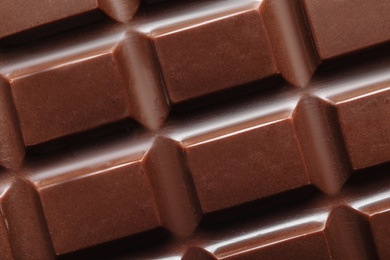 Tasty dark chocolate bar as background, top view