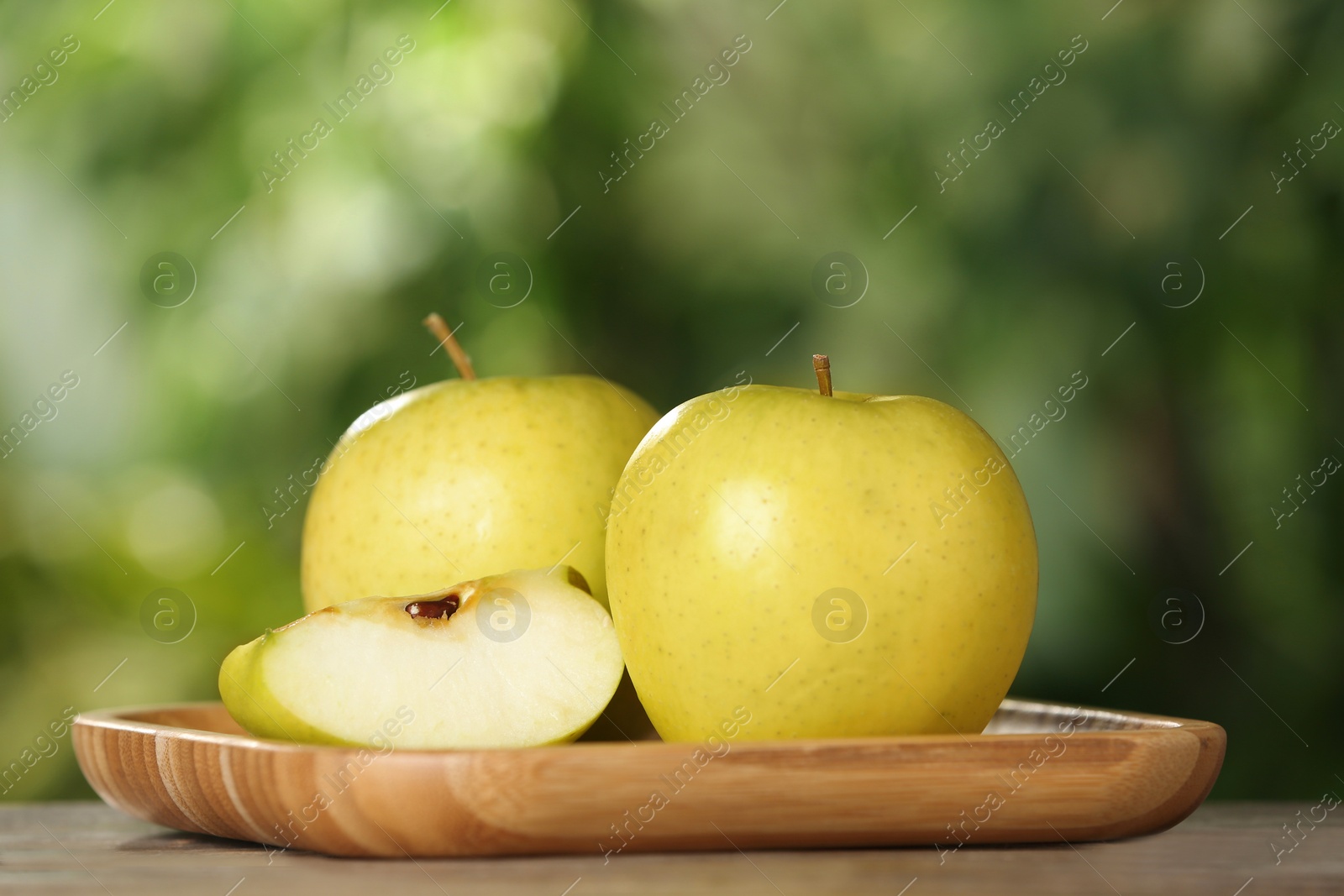 Photo of Fresh ripe juicy apples on wooden table