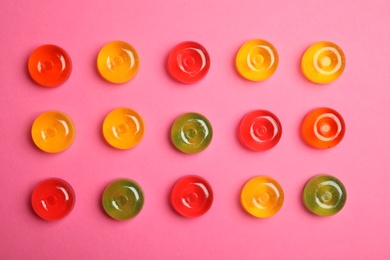 Photo of Flat lay composition with delicious colorful candies on color background