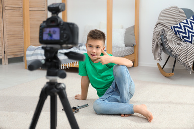 Photo of Cute little blogger recording video at home