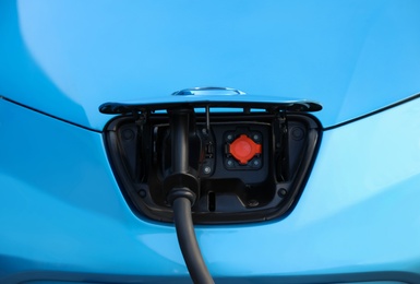Charging modern electric car from station, closeup