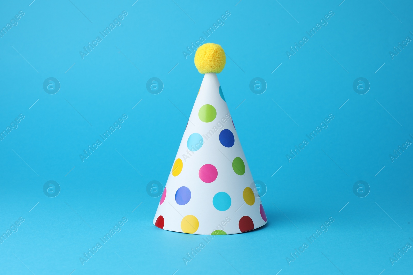 Photo of Colorful party hat on light blue background