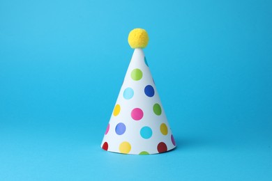 Photo of Colorful party hat on light blue background