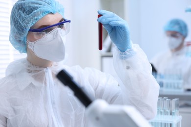 Scientist working with sample in test tube in laboratory