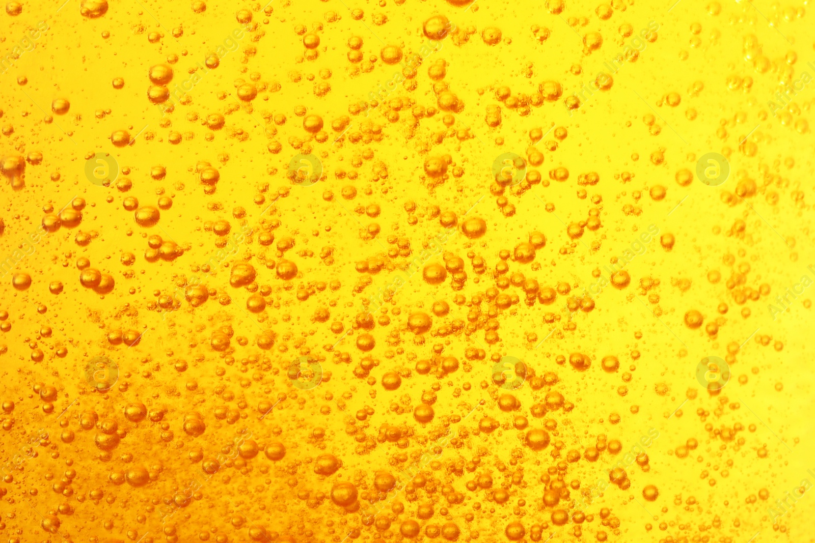 Photo of Tasty beer with bubbles as background, closeup