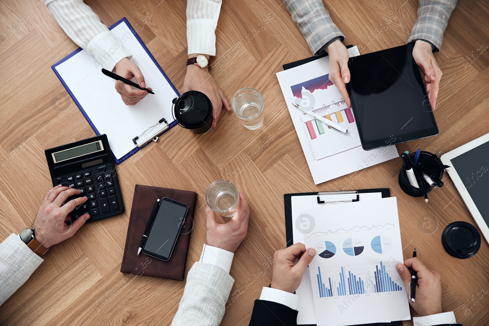 Photo of Businesspeople having meeting at table, top view. Management consulting