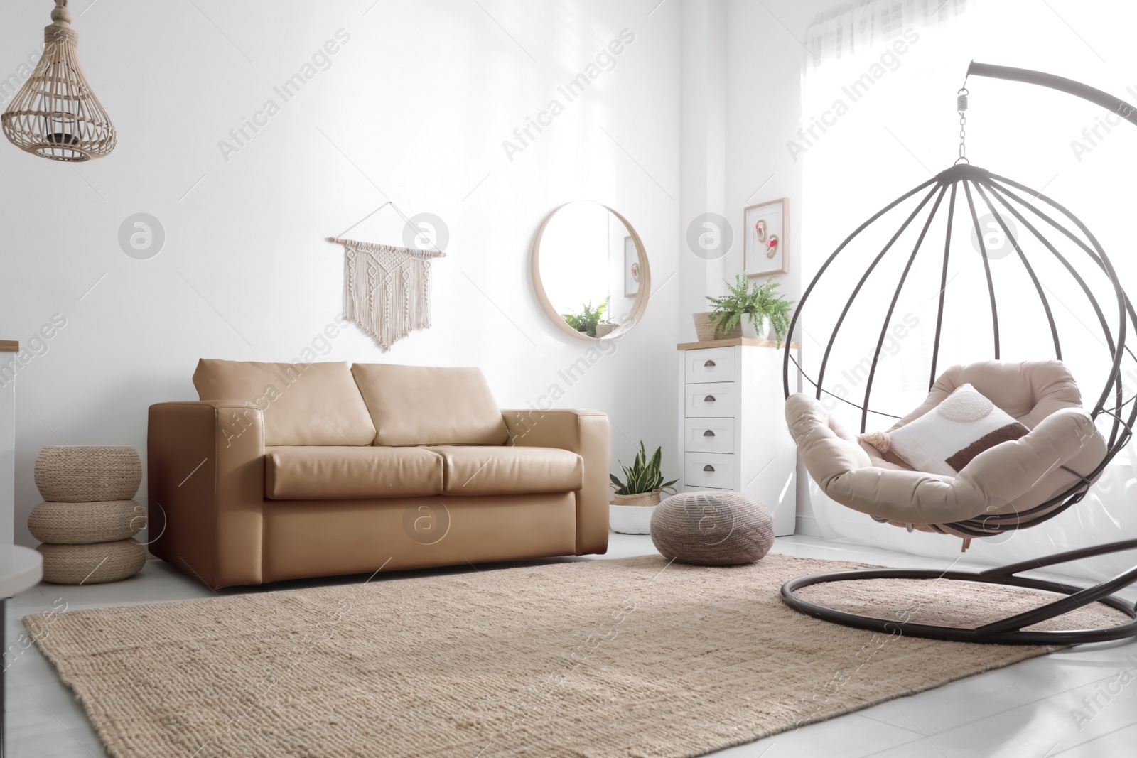 Photo of Stylish leather sofa and swing chair in modern living room interior