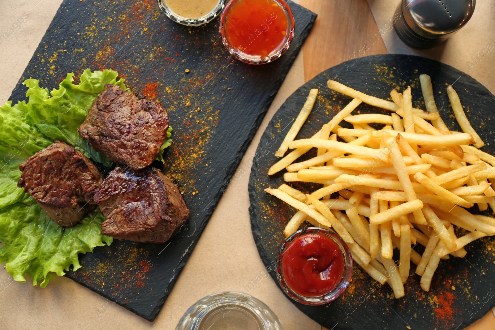 Photo of Tasty pieces of shish kebab served on slate plate in cafe