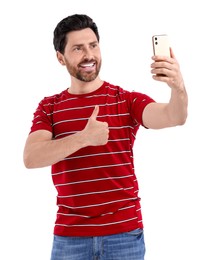 Photo of Smiling man taking selfie with smartphone and showing thumbs up on white background