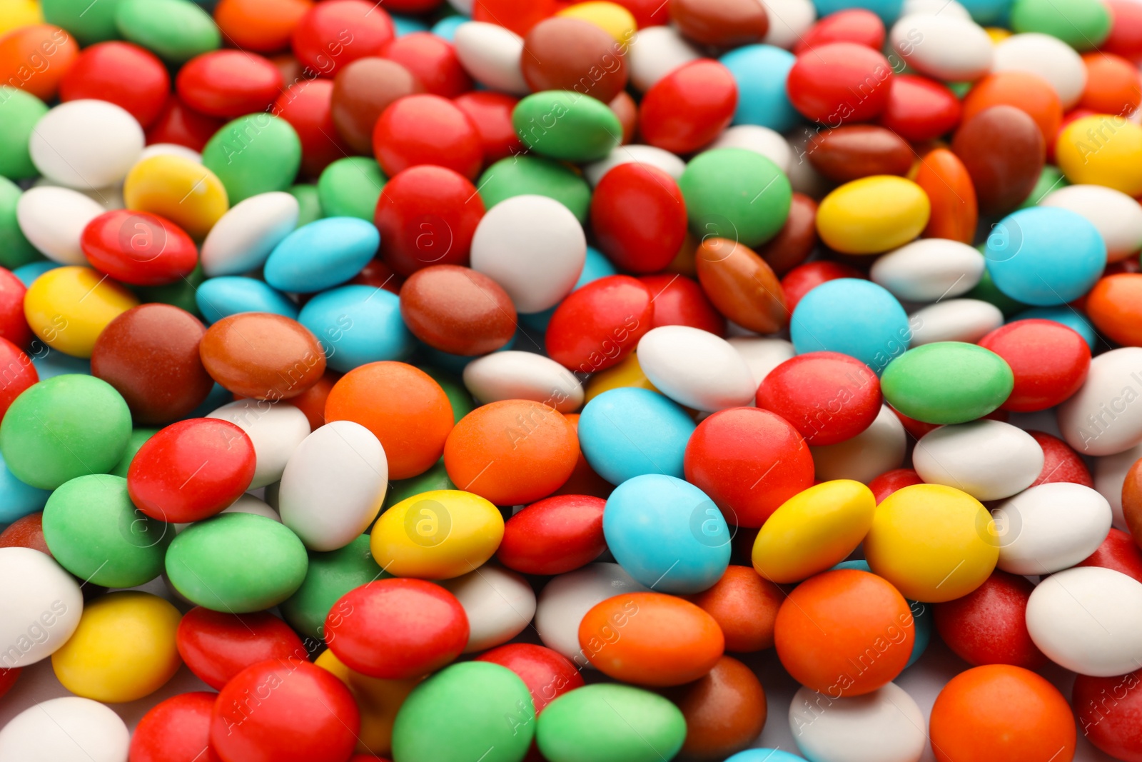 Photo of Many small colorful candies as background, closeup