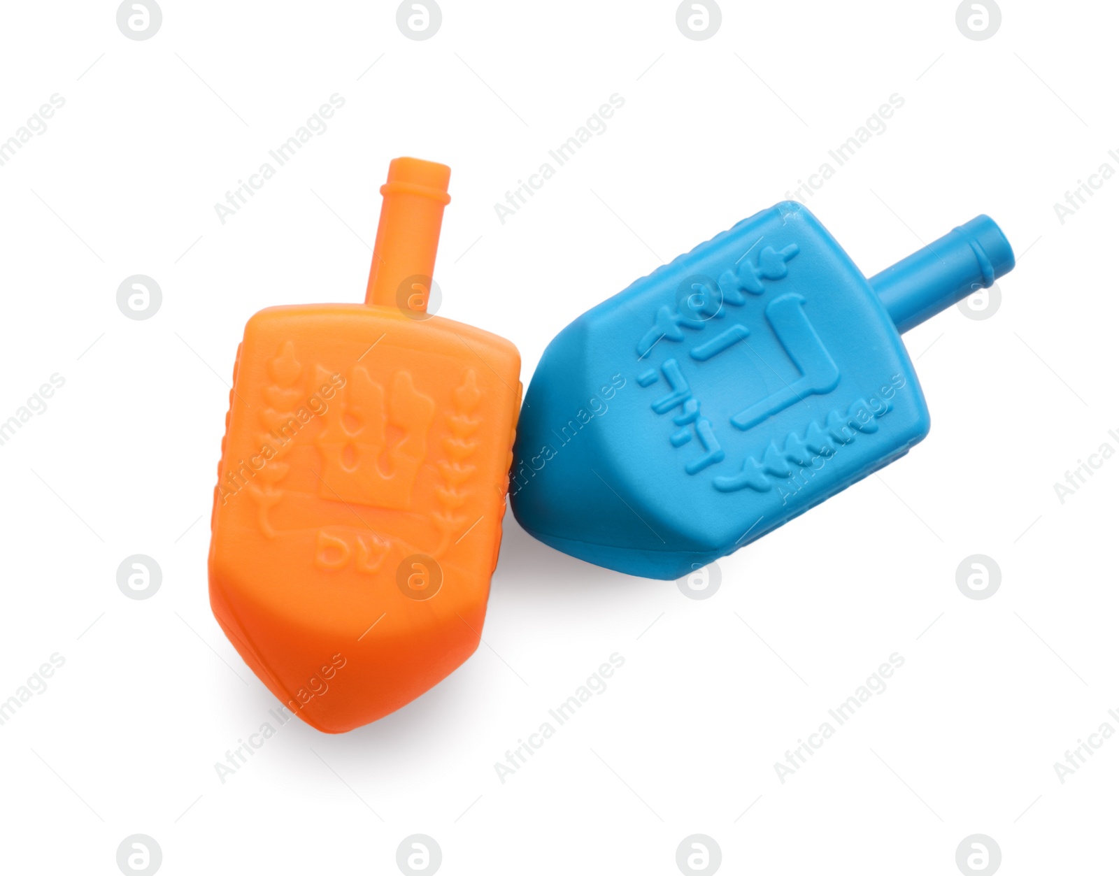 Photo of Colorful dreidels isolated on white, above view. Traditional Hanukkah game