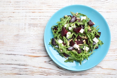 Photo of Fresh delicious beet salad on white wooden table, top view. Space for text