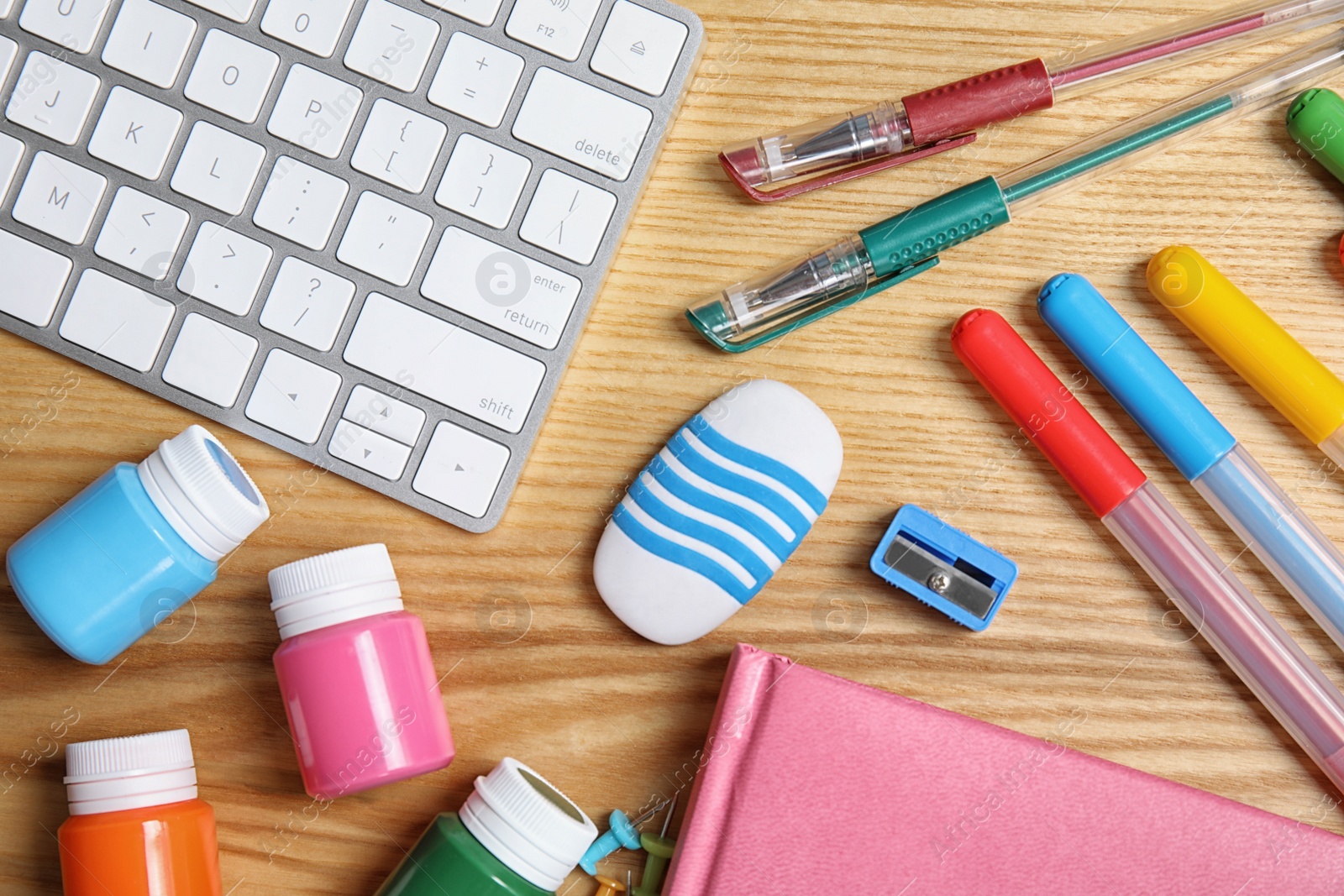 Photo of Different school stationery on wooden background, flat lay