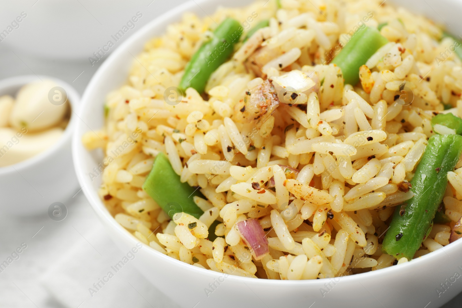 Photo of Tasty rice pilaf with vegetables on table, closeup