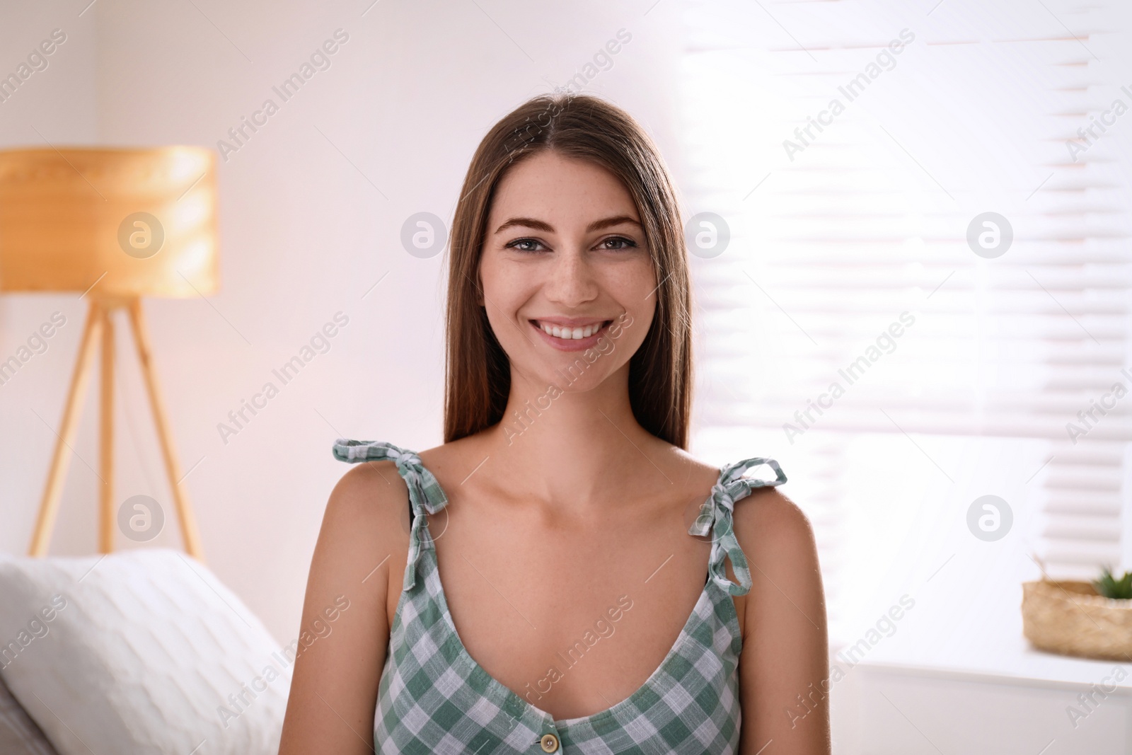 Photo of Young woman talking to his coworkers through video conference indoors, view from webcam