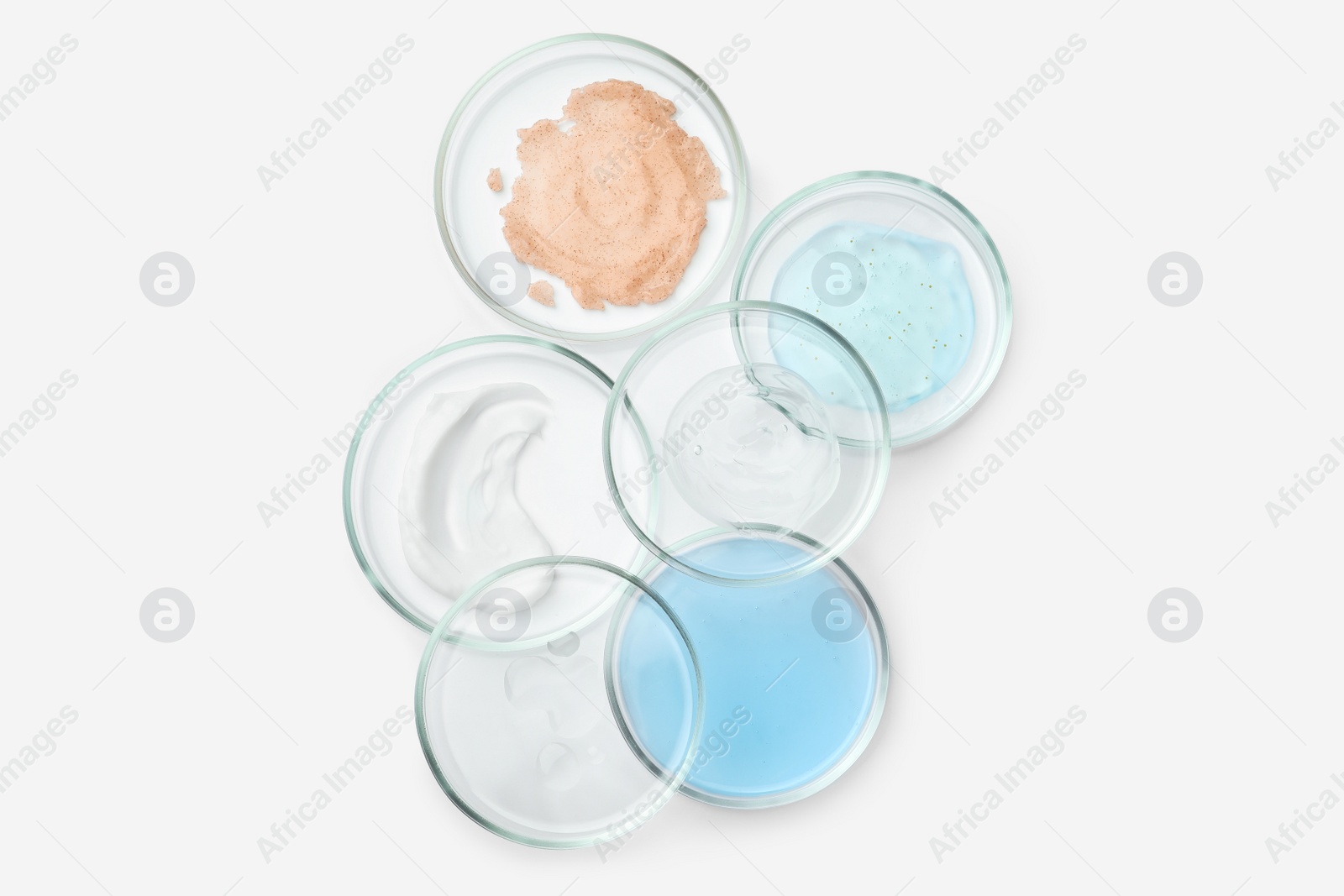 Photo of Many Petri dishes and cosmetic products on white background, top view