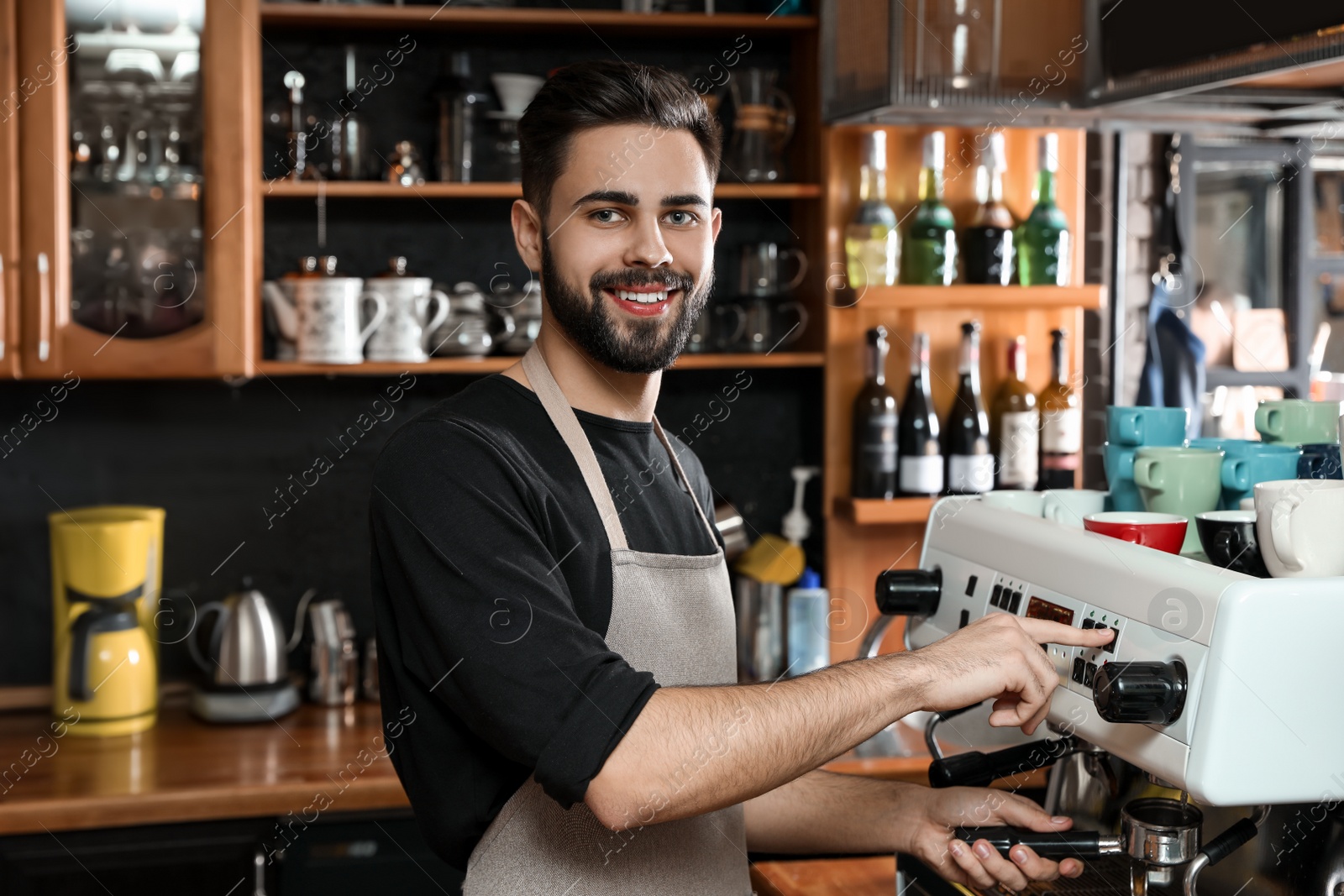 Photo of Barista cleaning portafilter at coffee machine in shop