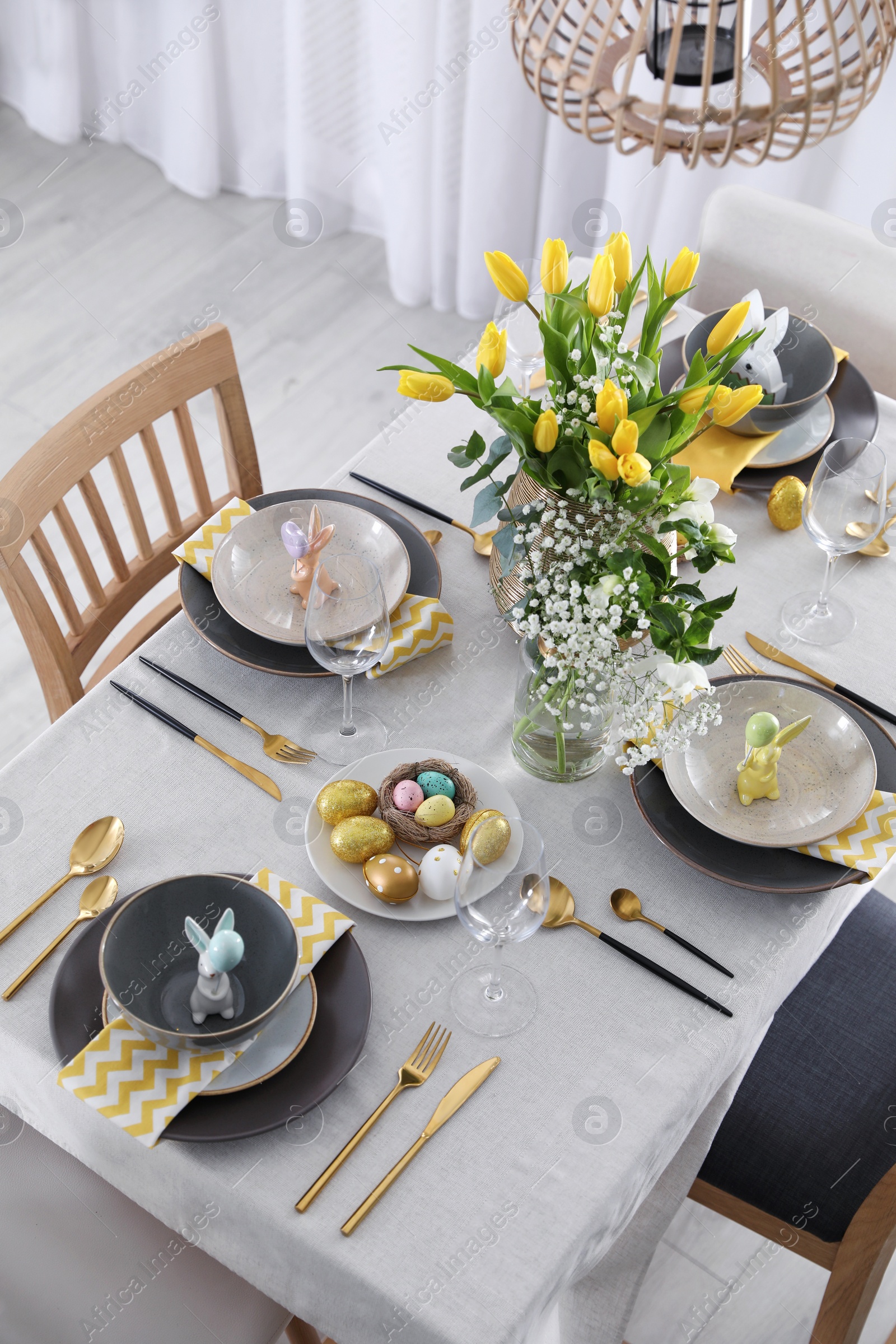 Photo of Beautiful Easter table setting with festive decor indoors, above view