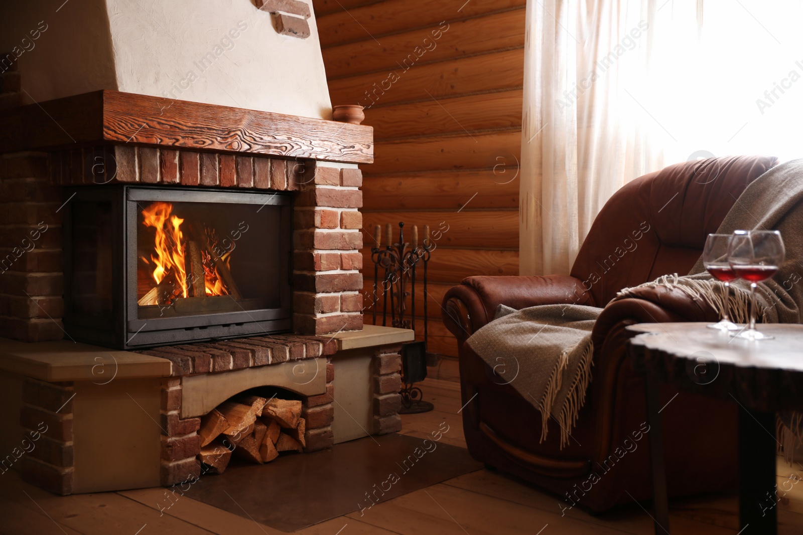 Photo of Modern cottage interior with stylish furniture and fireplace. Winter vacation