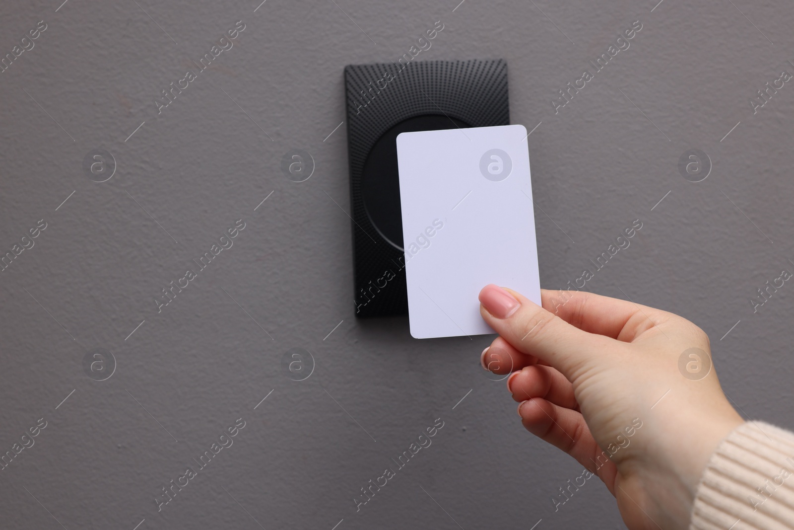 Photo of Woman opening magnetic door lock with key card, closeup and space for text. Home security