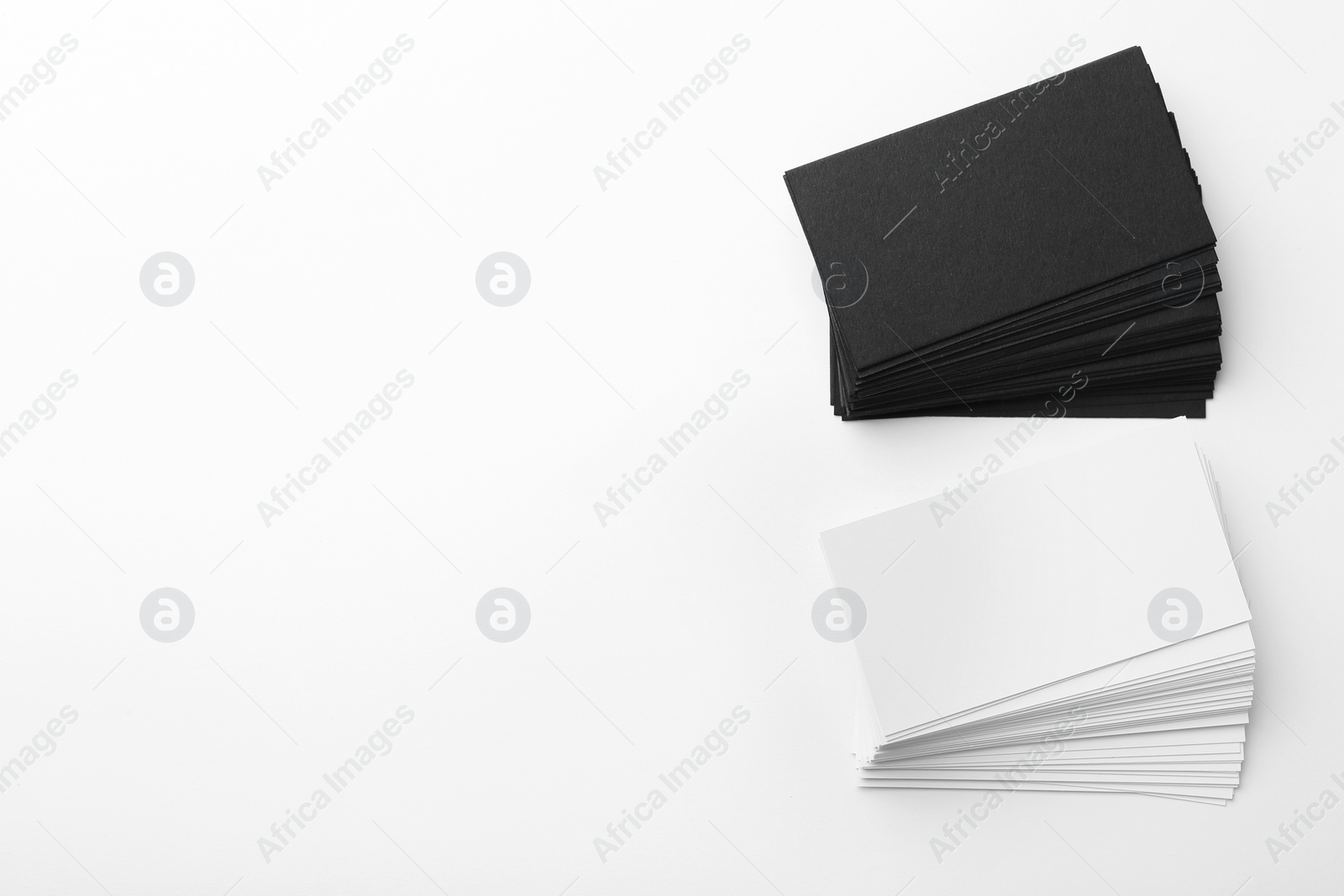 Photo of Blank business cards on white background, flat lay. Mockup for design