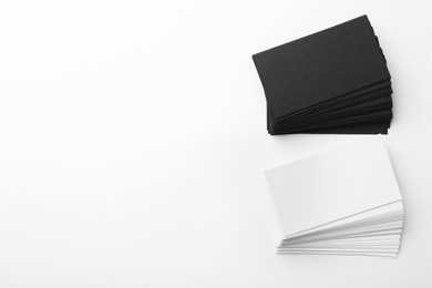 Photo of Blank business cards on white background, flat lay. Mockup for design