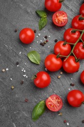 Photo of Ripe tomatoes, basil and spices on gray textured table, flat lay