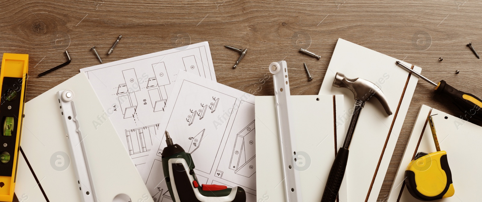 Image of Flat lay composition with furniture assembly parts and tools on wooden background. Banner design